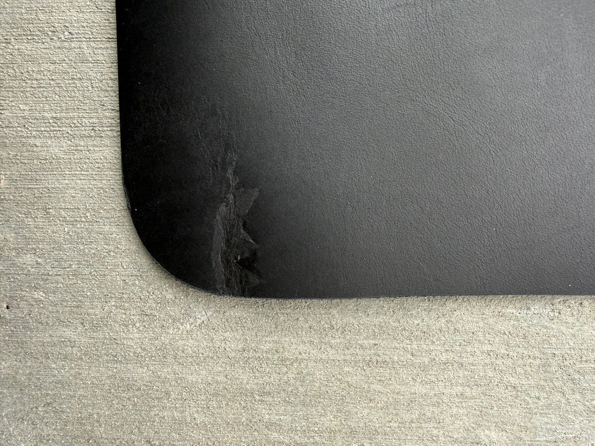 Close-up of the top-right corner scuff on an A5 black veg-tan journal