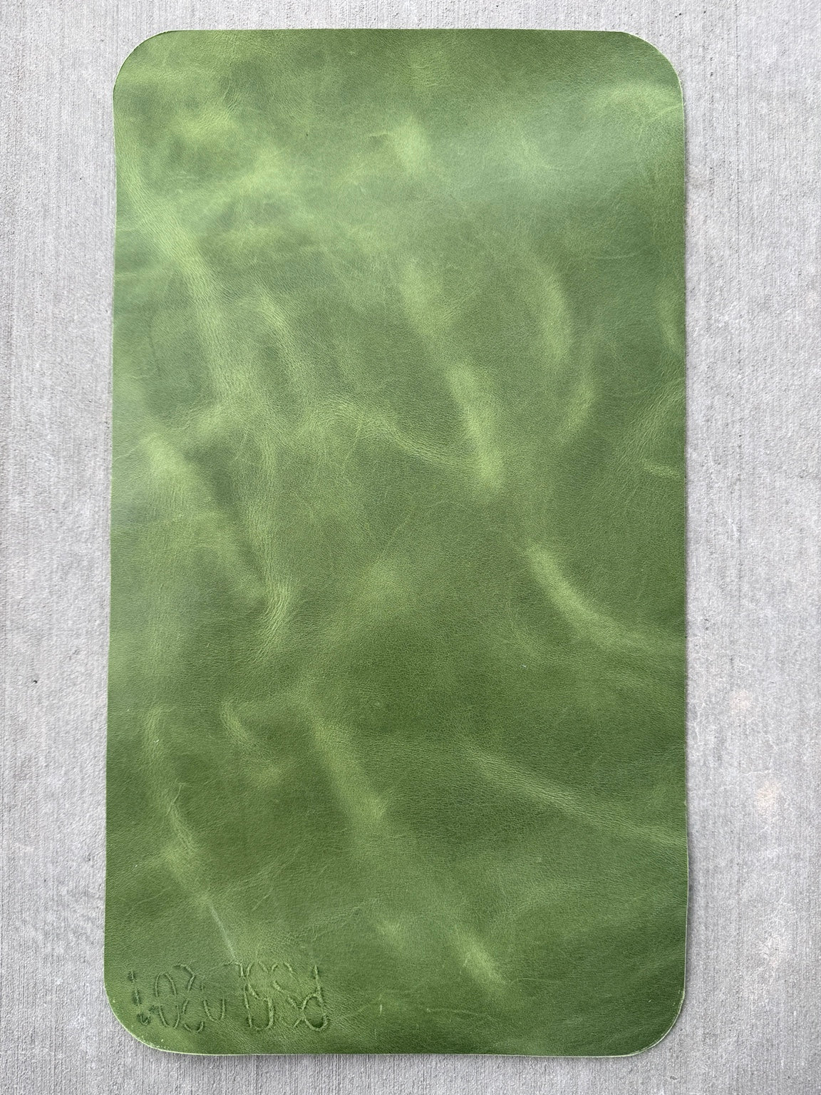 Branded letters and numbers on the side of an A5 green Studio Seconds journal