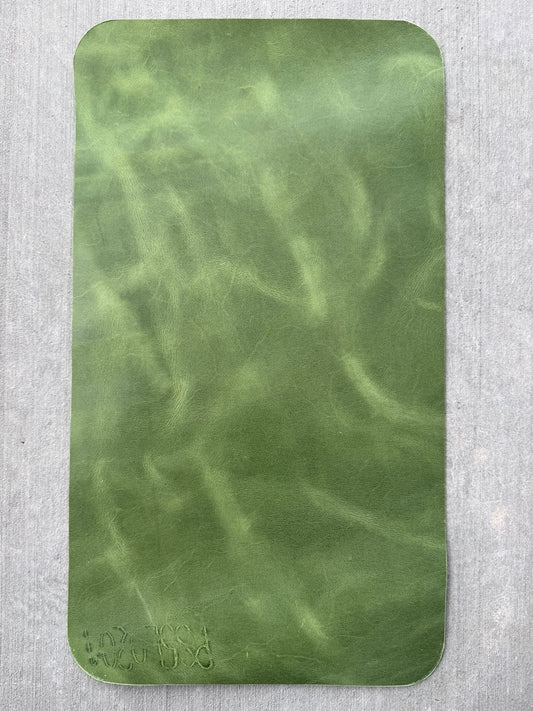 Branded letters and numbers on the side of an A5 green Studio Seconds journal