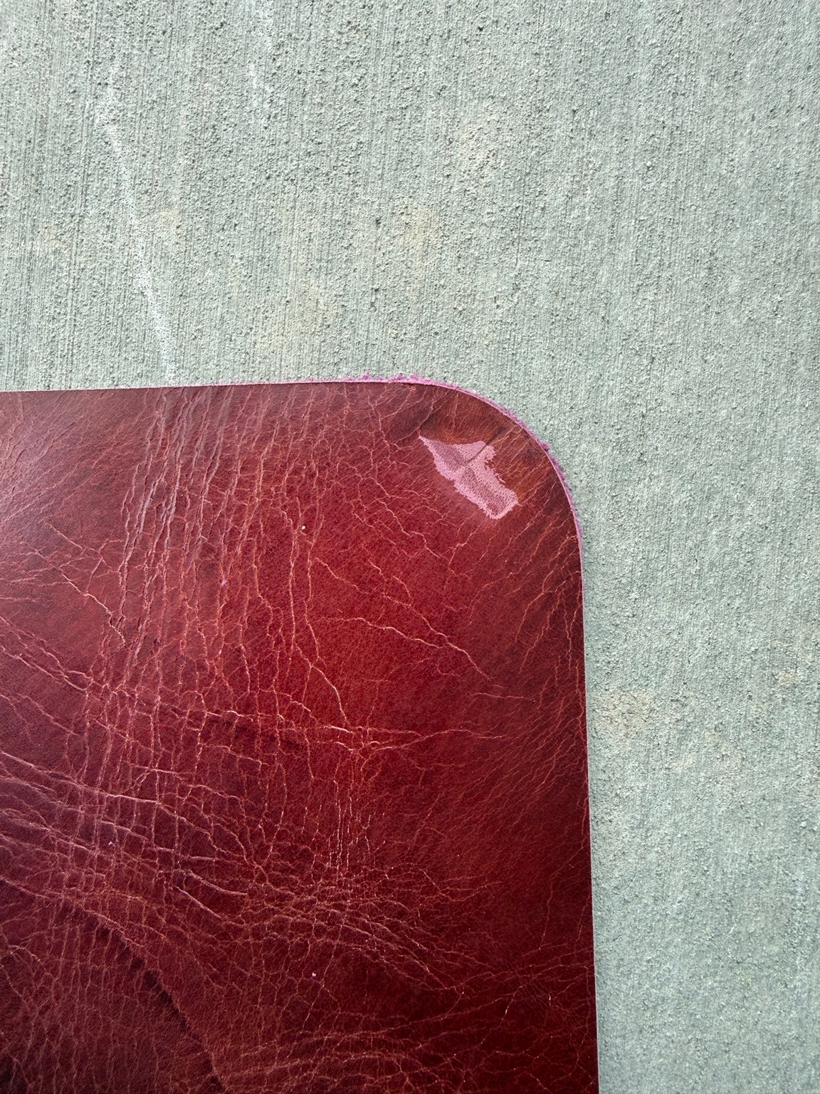 Close-up of the bottom-right corner scuff on an A5 maroon journal