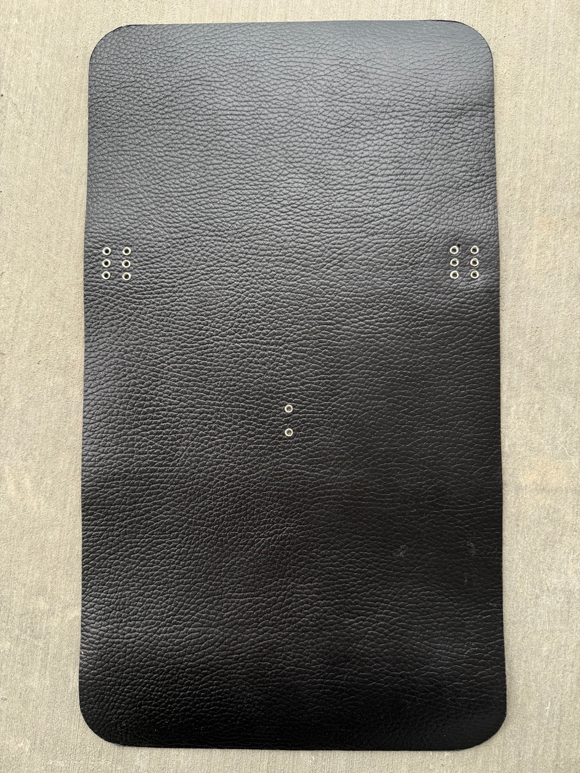 A5 pebbled black Studio Seconds journal with silver grommets