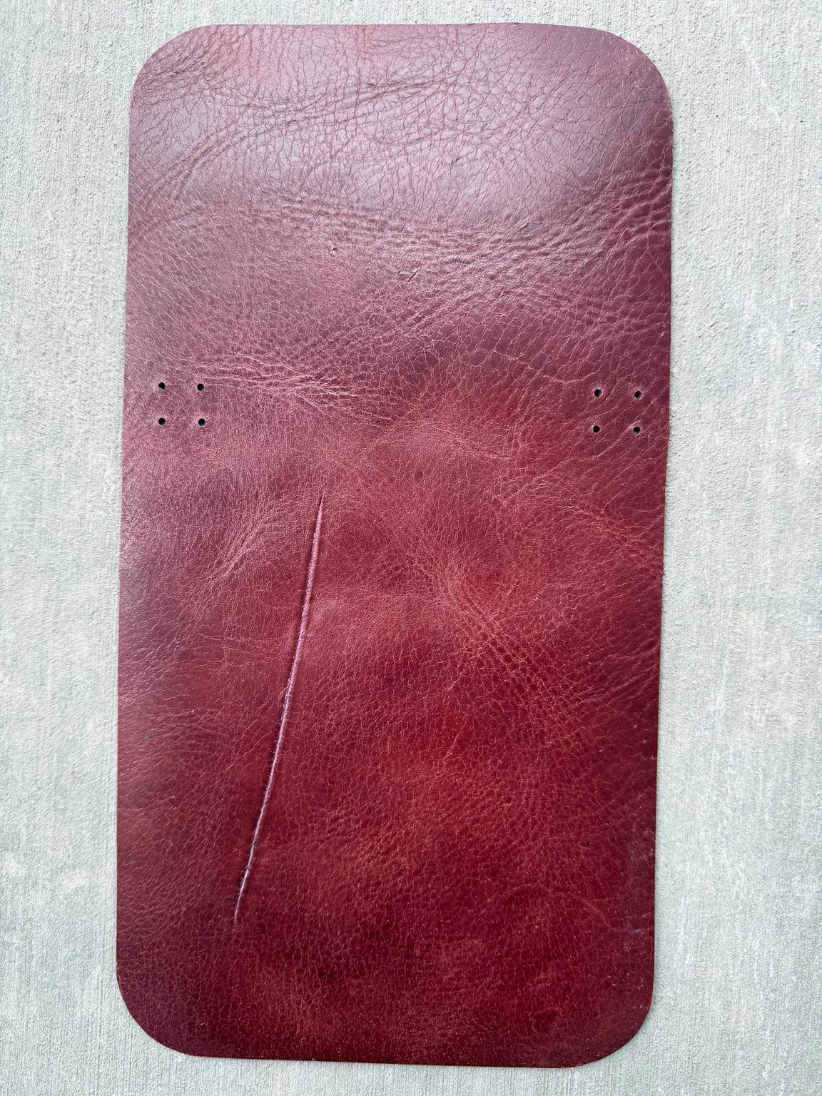Major scratch line across the back of an A6 pocket maroon Studio Seconds journal